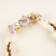 Daisy Chain — close-up of the clear quartz beads, open-heart motif and flower details